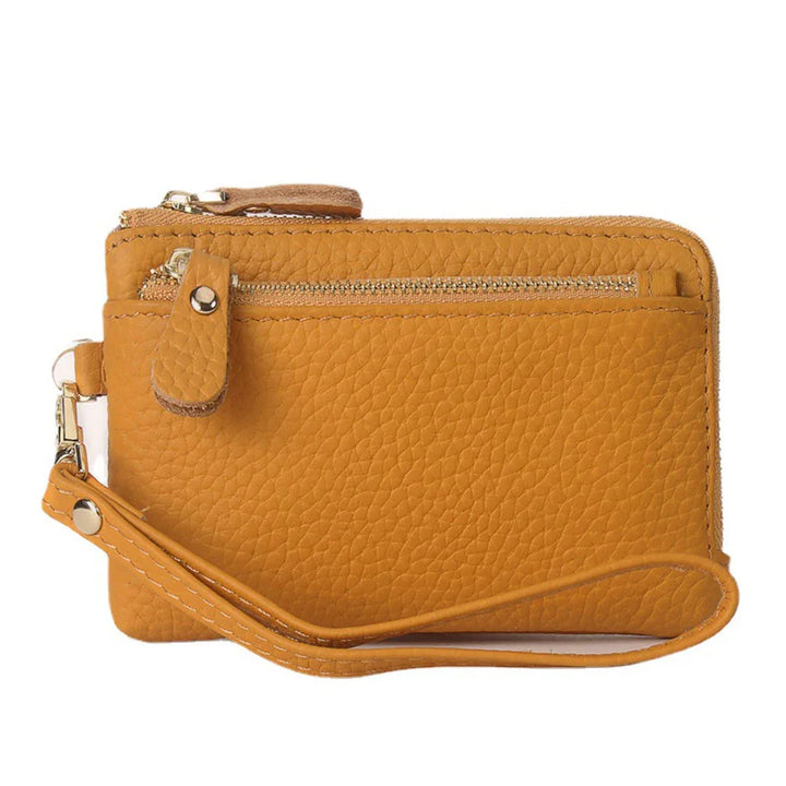 Mustard yellow textured leather wristlet with zippered pocket and detachable strap