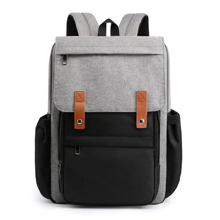 Modern two-tone gray and black backpack with brown strap accents and multiple zippered pockets