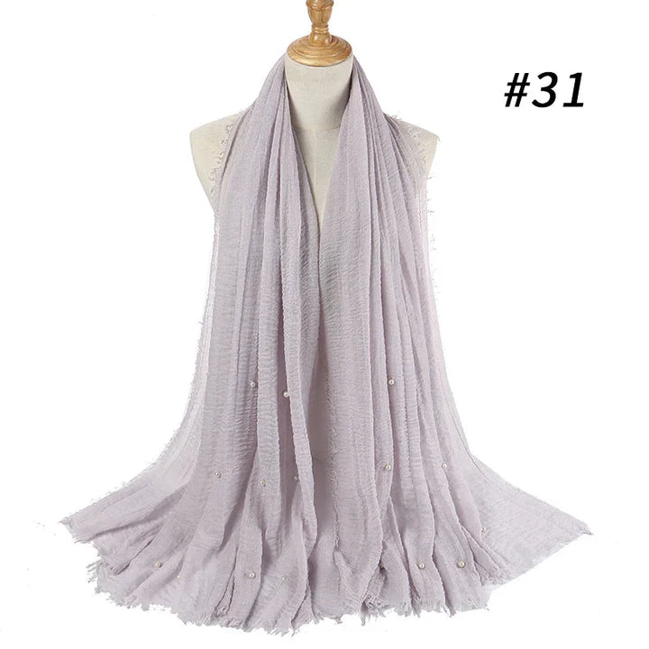 Light lavender crinkled scarf with small pearl accents displayed on mannequin torso