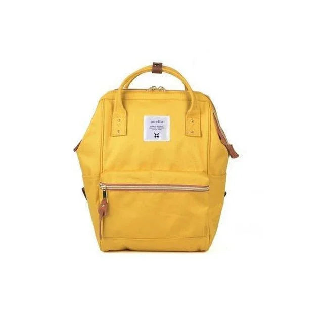Yellow Anello backpack with front zipper pocket and dual top handles on white background