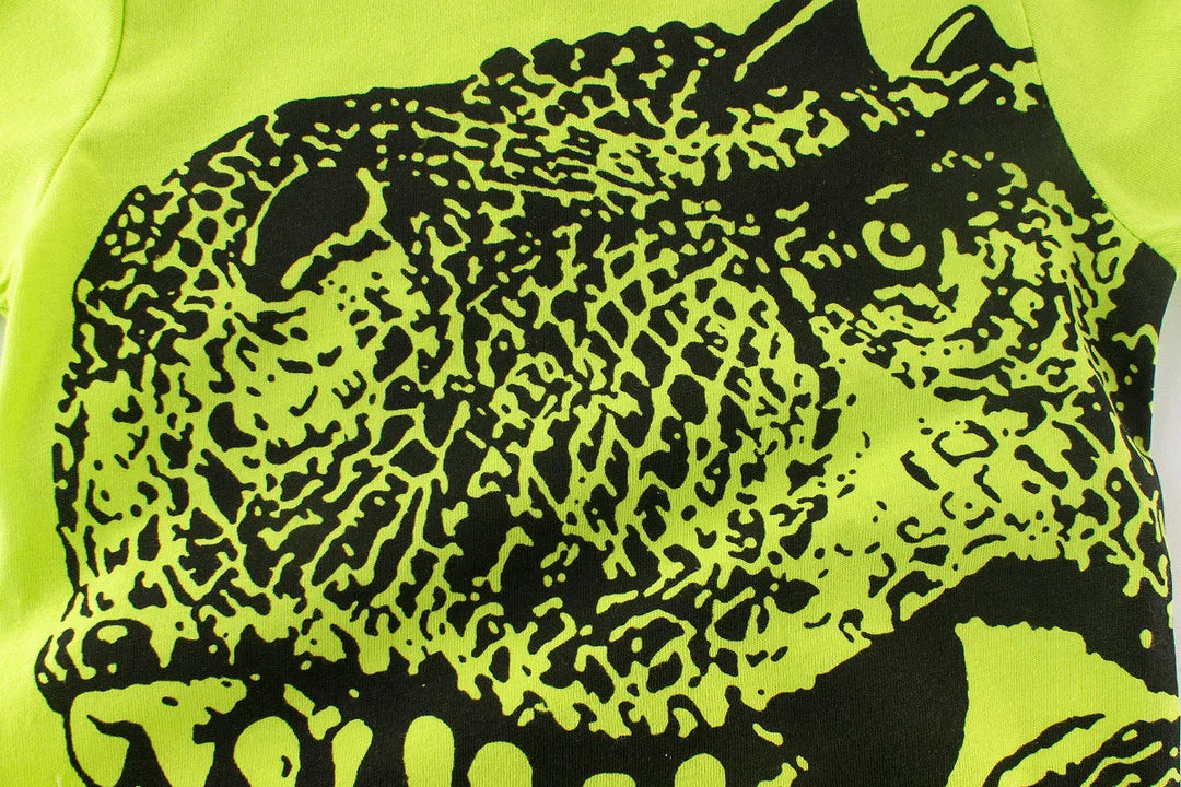 Close-up of neon green fabric with detailed black leopard print design