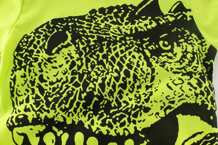 Close-up of neon green fabric with detailed black leopard print design