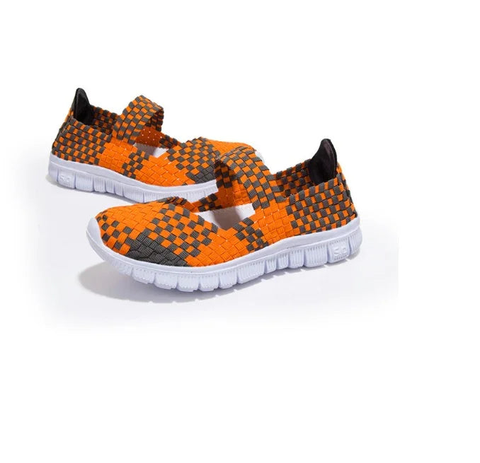 Pair of orange and gray woven slip-on casual shoes with white flexible soles on white background