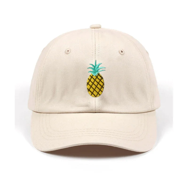 Beige baseball cap with embroidered yellow pineapple and green leaves design