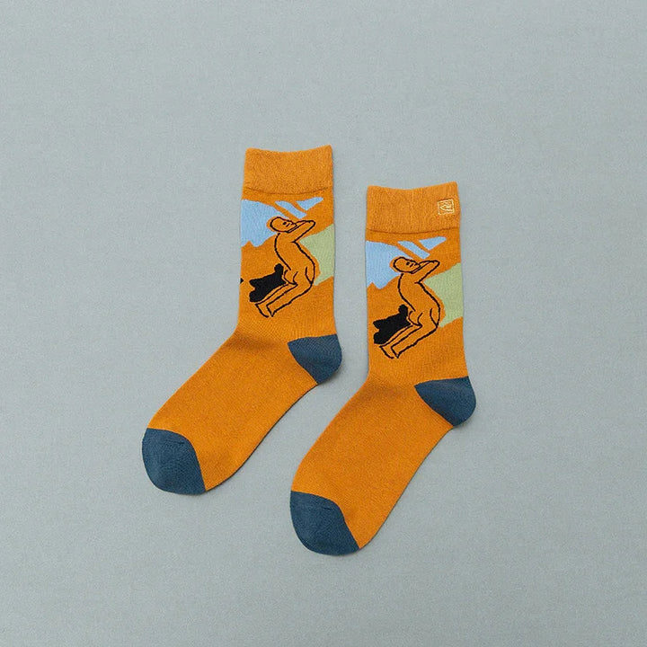 Orange socks with blue toes and cactus design on a light gray background