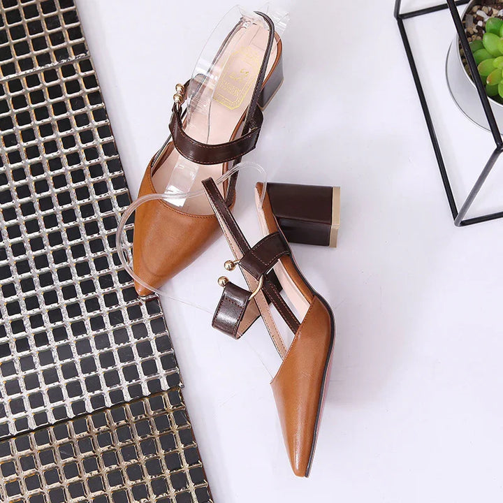 Pair of brown leather block heel slingback shoes with dark brown straps and gold accents
