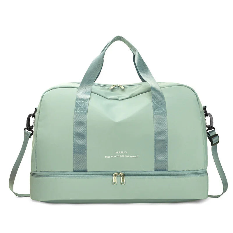 Light green travel duffel bag with double handles, shoulder strap, and bottom zipper compartment