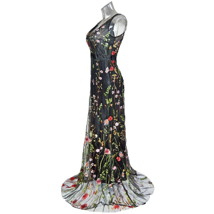 Black sheer sleeveless evening gown with colorful floral embroidery and floor-length train