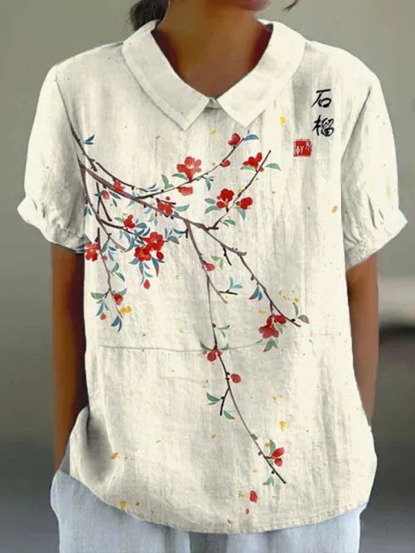 White short-sleeve blouse with Peter Pan collar and red floral branch design on front
