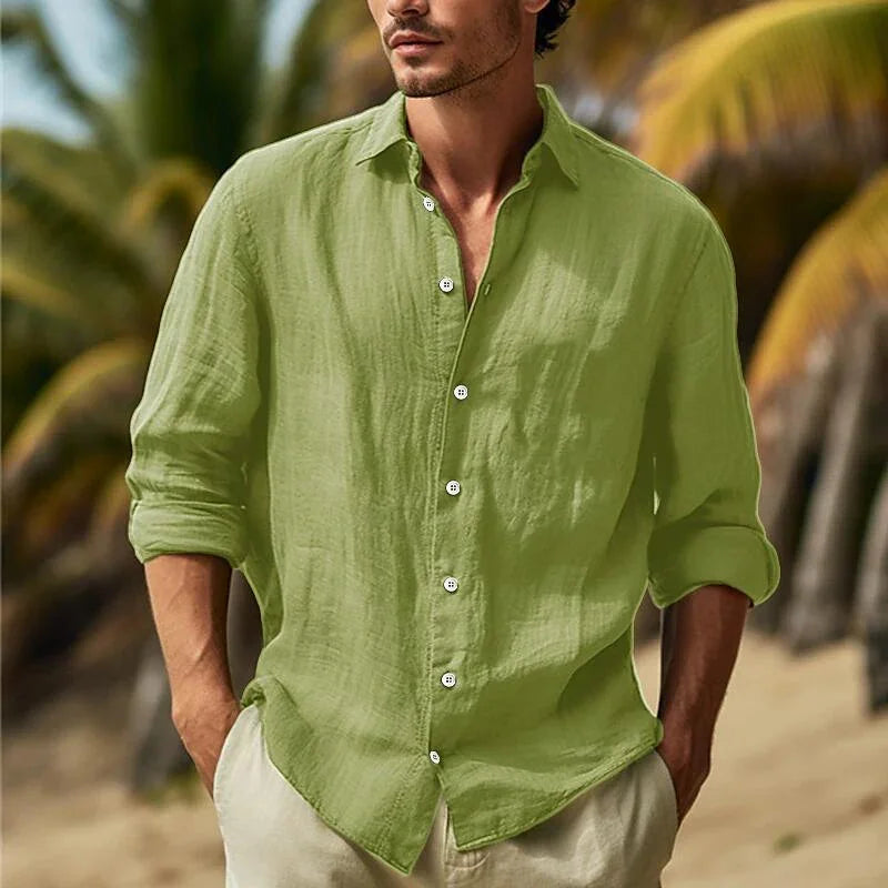 Man wearing light green linen shirt with rolled sleeves on tropical beach background