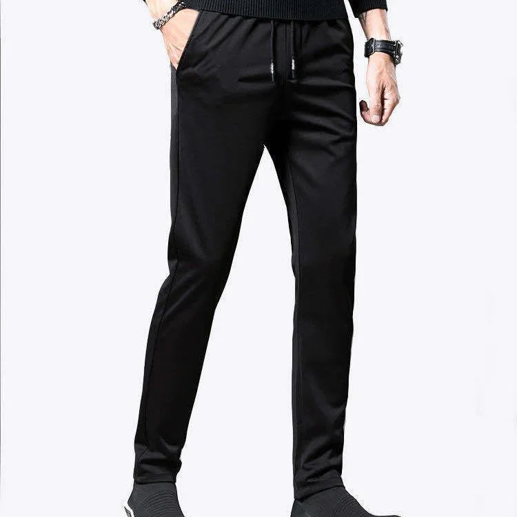 Mens slim fit black jogger pants with side pockets and drawstring waist styled with black sweater