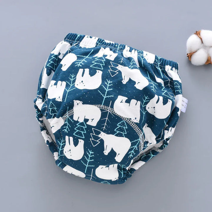 Blue baby training pants with white bear and tree prints on gray background