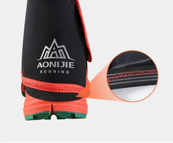 Close-up of Aonijie running shoe cover in black and red with detailed stitching on sole