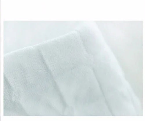 Close-up of soft, plush white fabric with visible texture and folds