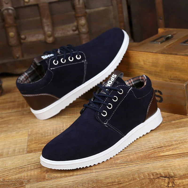 Navy blue casual sport shoes with white soles and plaid inner lining on wooden floor