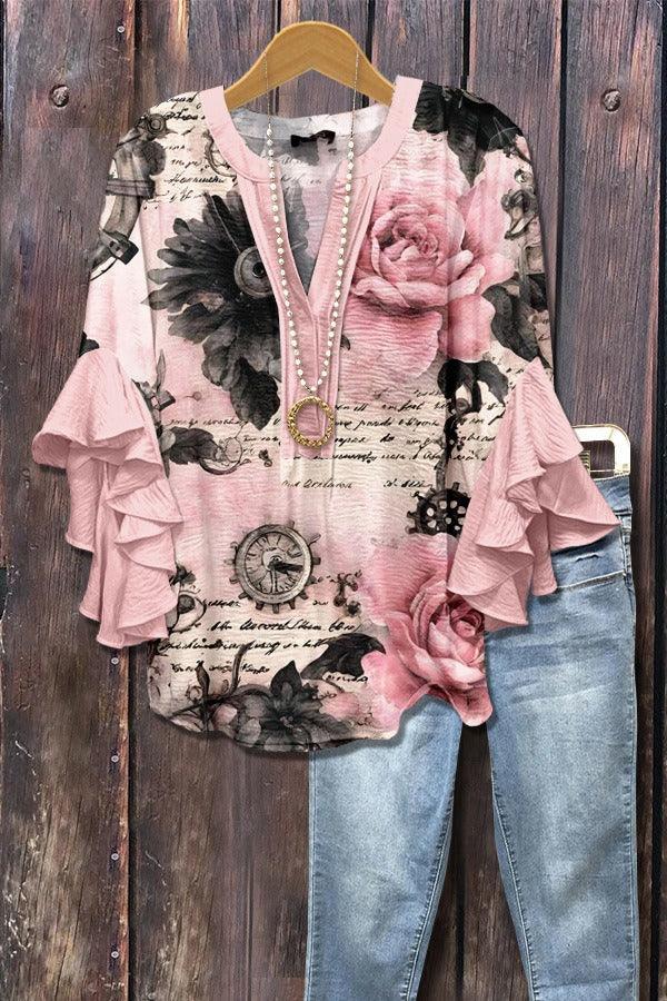 Pink floral ruffle sleeve blouse with vintage clock print paired with blue jeans on wooden background