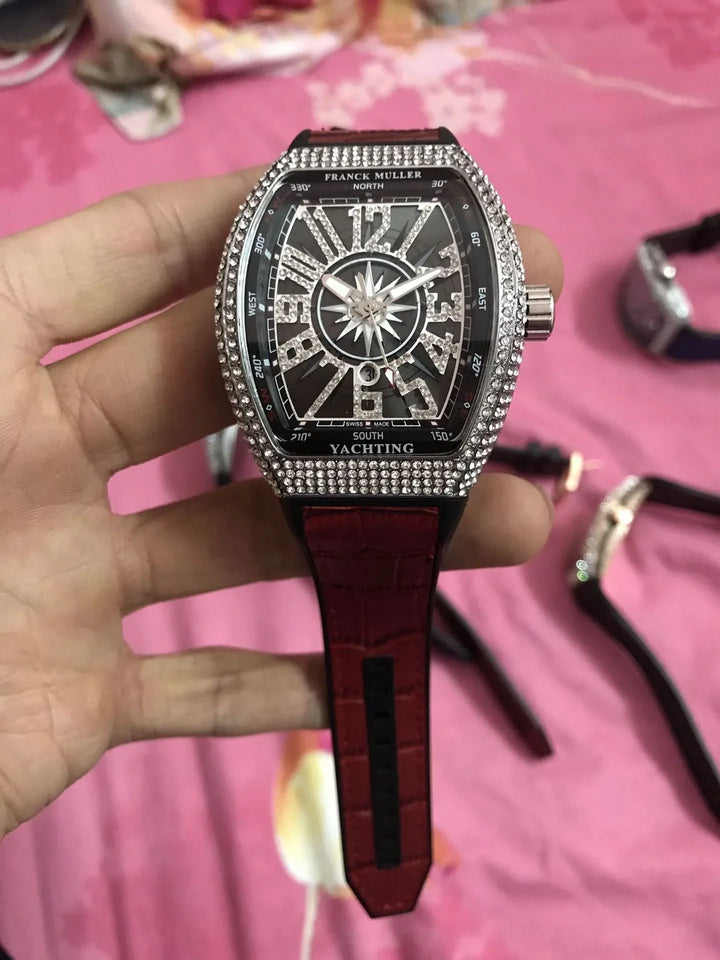 Franck Muller Yachting watch with diamond-studded bezel and red leather strap, held in hand