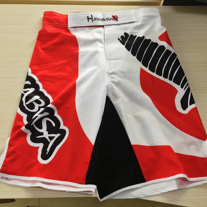 Hayabusa red and white MMA fight shorts with bold black logo and graphic detailing