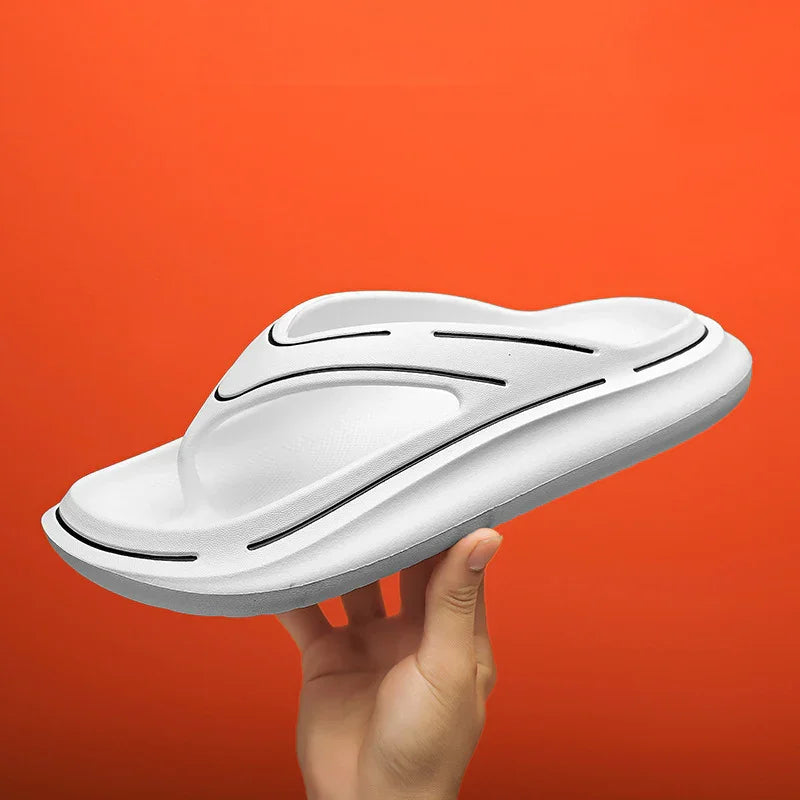 Hand holding white ergonomic orthotic sandal with black accents against orange background