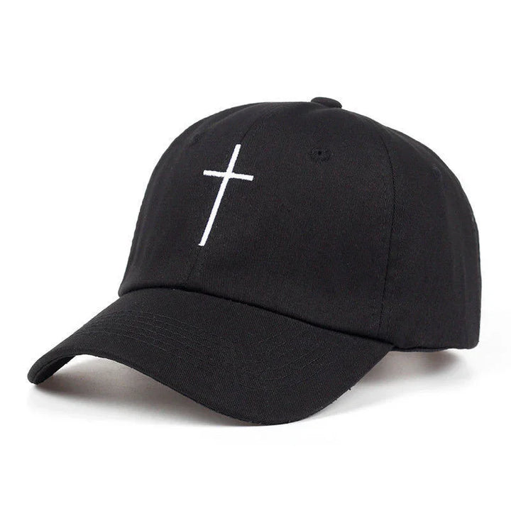 Black baseball cap with white embroidered cross on front, curved brim, and adjustable back