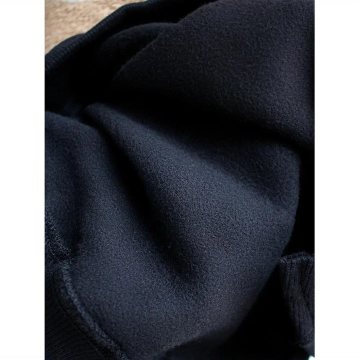 Close-up of soft dark navy fleece fabric showing texture and stitching details