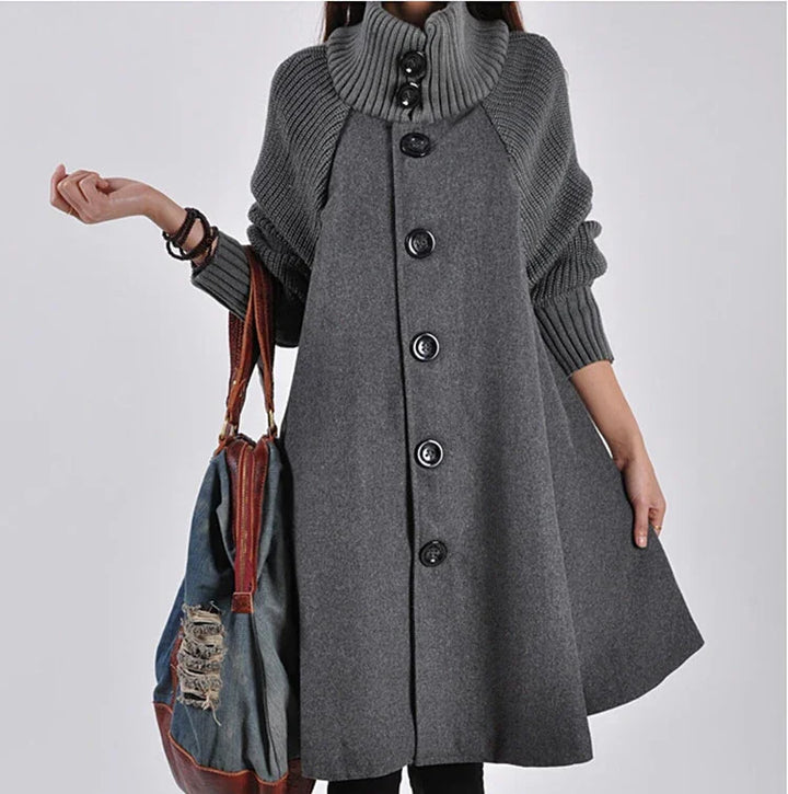 Woman wearing gray wool coat with large buttons and ribbed collar, holding distressed denim and leather bag