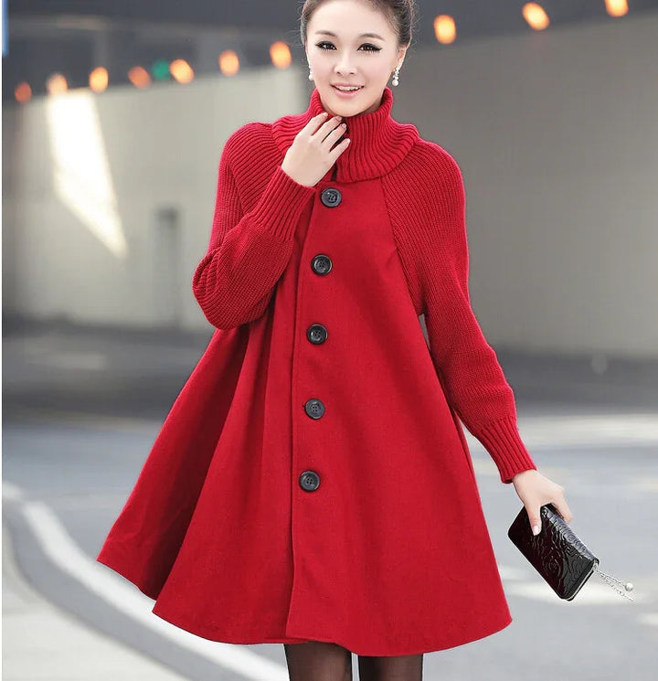 Woman wearing a stylish red buttoned wool coat with high collar holding a black clutch