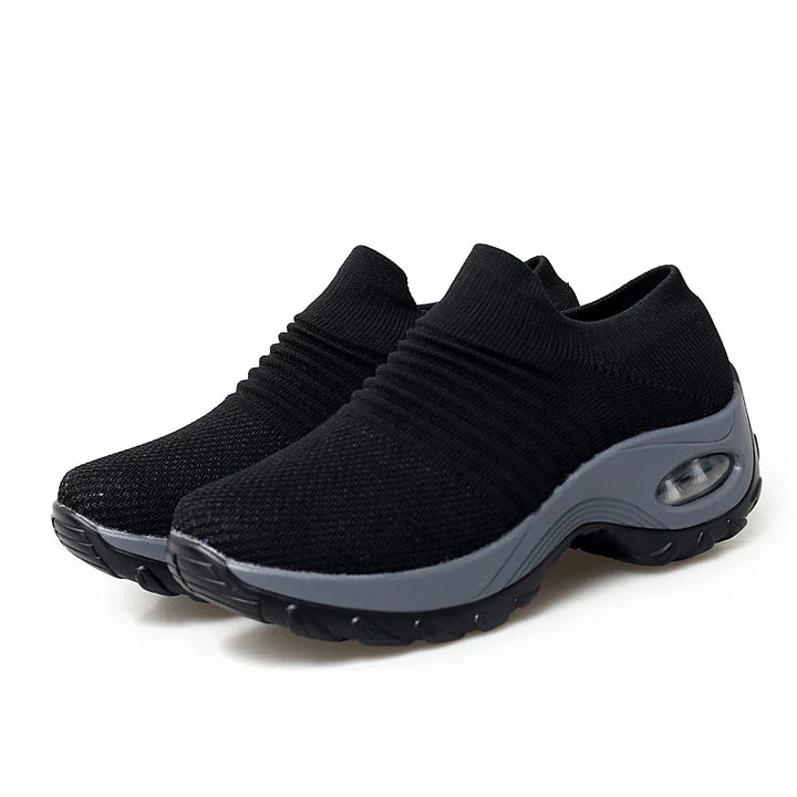 Black slip-on knit sneakers with gray cushioned sole and air cushion detail, lightweight casual shoes