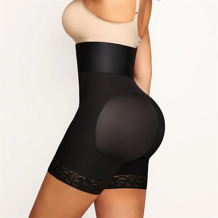 Woman wearing black high-waisted butt-lifting shapewear shorts with lace trim and beige top