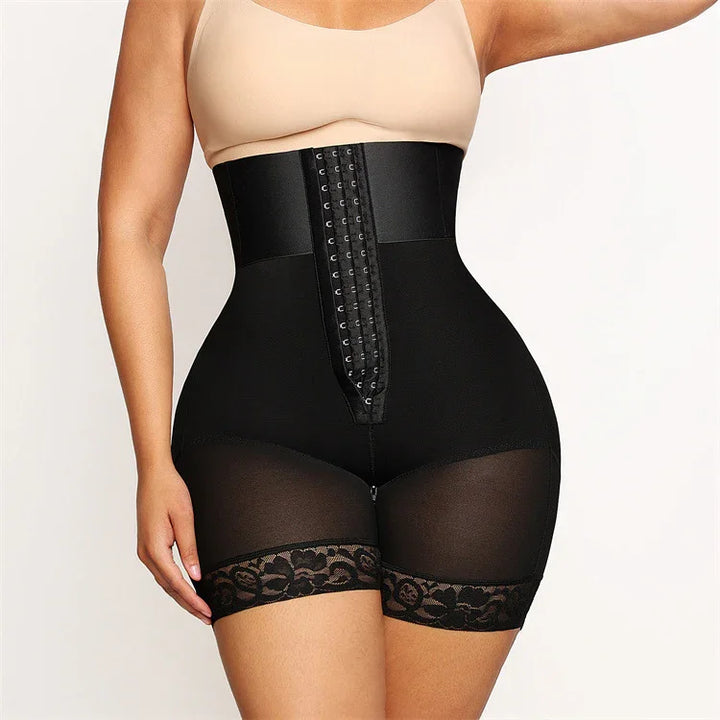 Woman wearing black high-waisted waist trainer shorts with lace trim and hook-and-eye closure