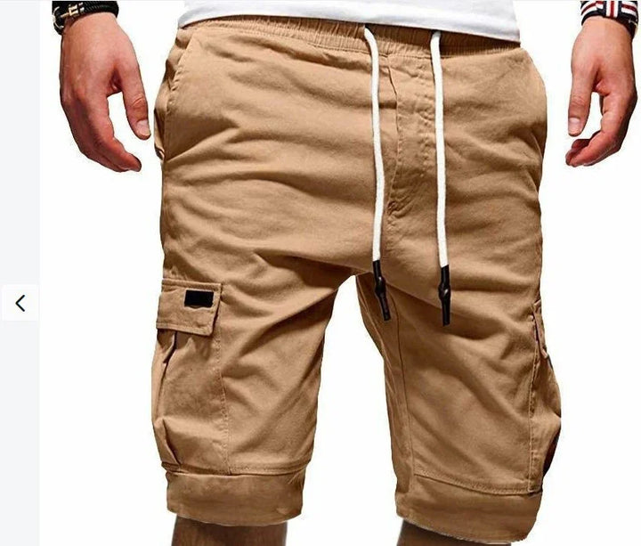 Men's beige cargo shorts with side pockets and white drawstring waist on white background