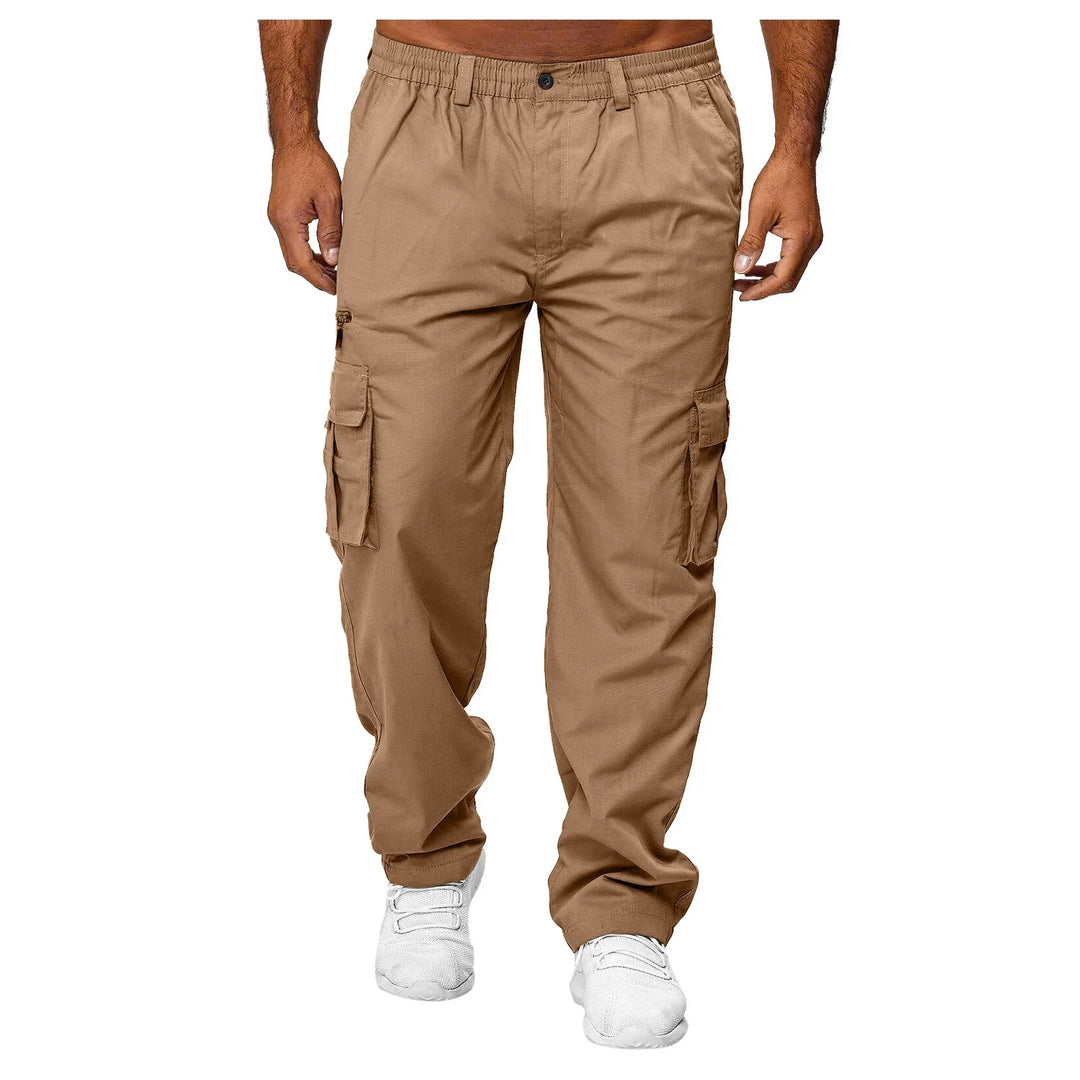 Men's tan cargo pants with multiple pockets and elastic waistband, paired with white sneakers