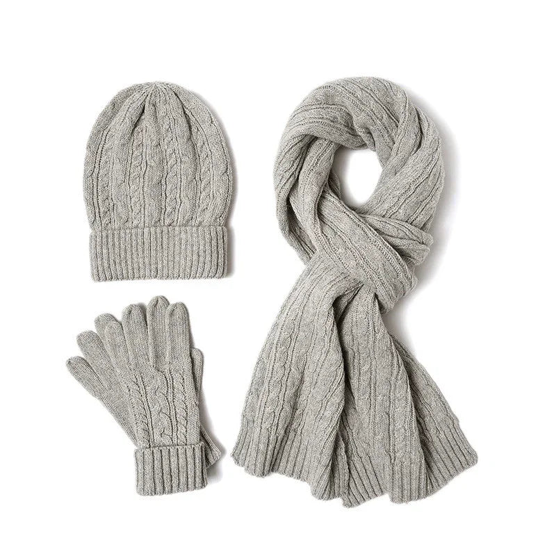 Gray cable knit winter hat, gloves, and scarf set on white background