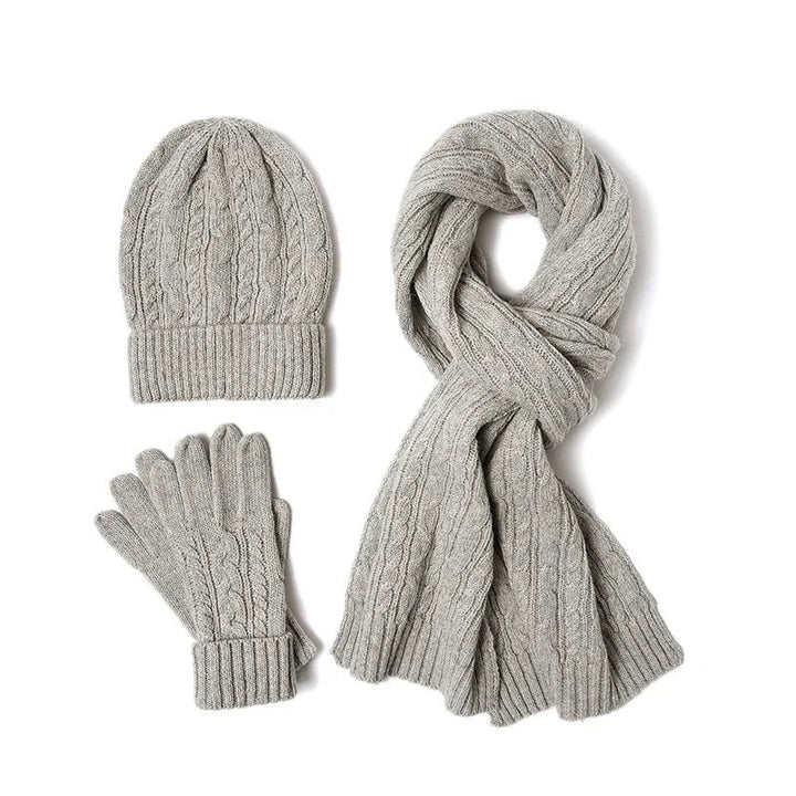 Gray cable knit winter hat, gloves, and scarf set on white background