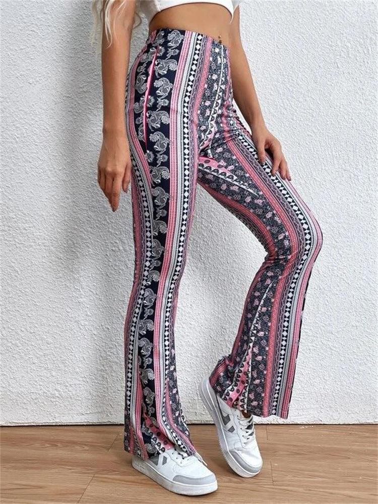 Woman wearing high-waisted, patterned flare pants with pink, black, and white vertical stripes and white sneakers