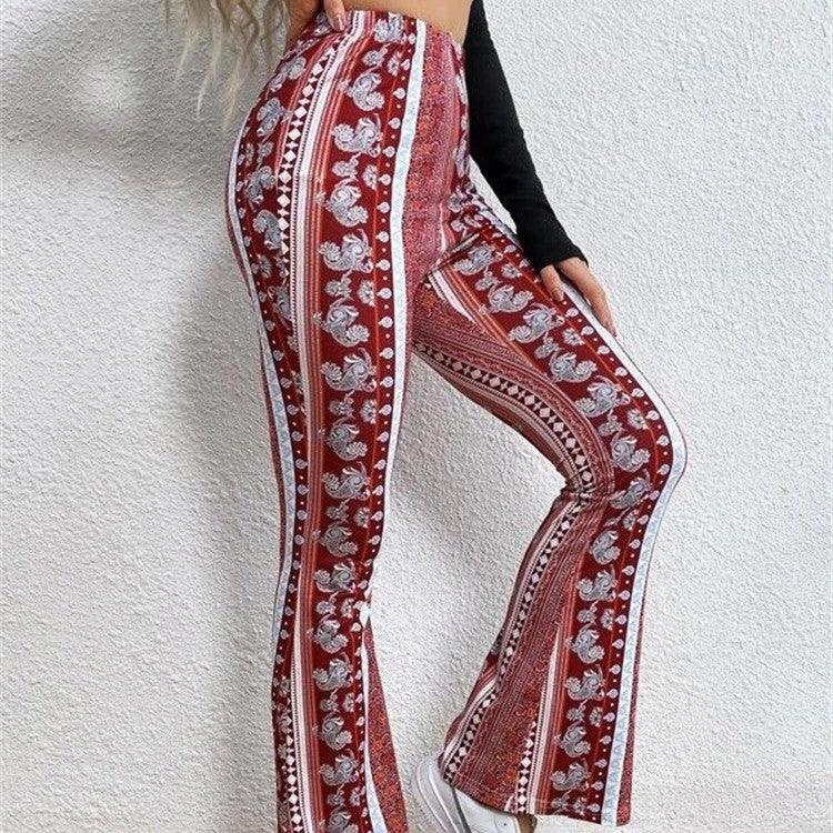 Woman wearing red patterned flared pants with white floral and geometric designs