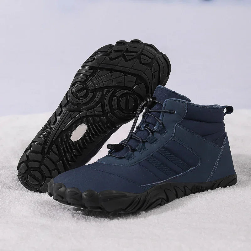 Navy blue outdoor hiking shoes with black flexible rubber soles on white surface