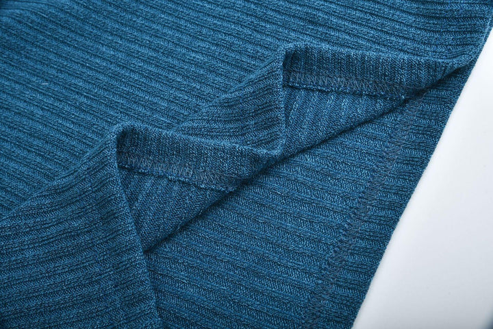 Close-up of folded blue ribbed knit fabric with visible stitching detail
