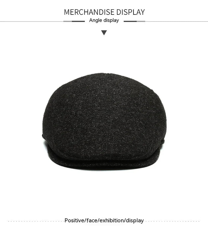 Black wool flat cap displayed on white background, merchandise angle view