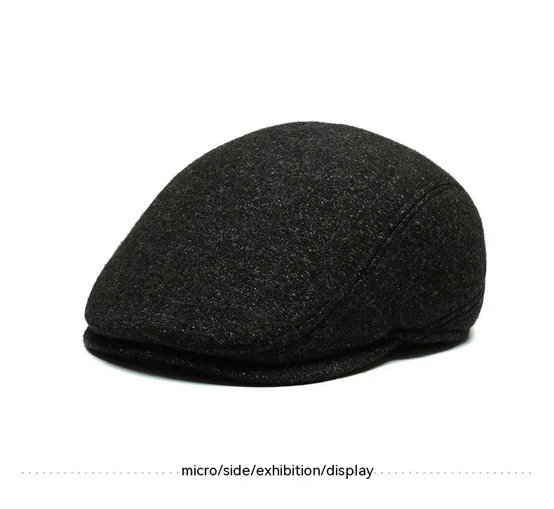 black flat cap hat with rounded shape and textured fabric on white background