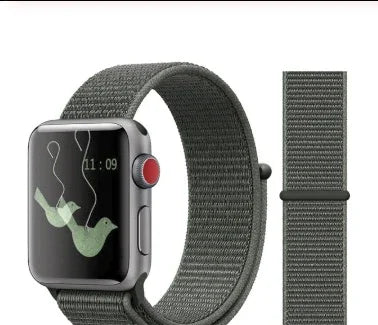 Gray woven fabric Apple Watch band with silver watch showing a bird wallpaper and time 11:09