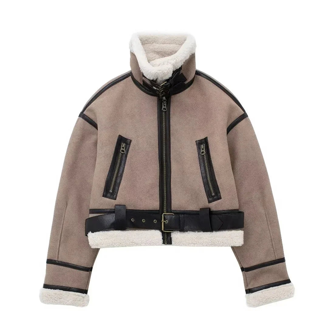 Beige cropped shearling jacket with black leather trim, zippered pockets, and belted waist