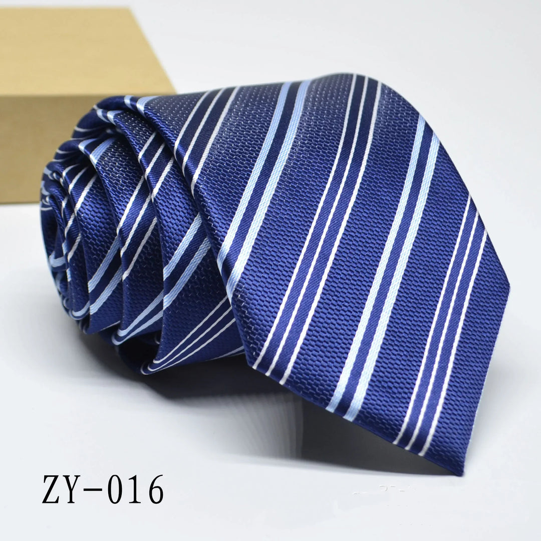 Rolled blue men's necktie with light and dark diagonal stripes on white surface