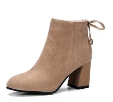 taupe suede ankle boot with block heel and back bow detail on white background