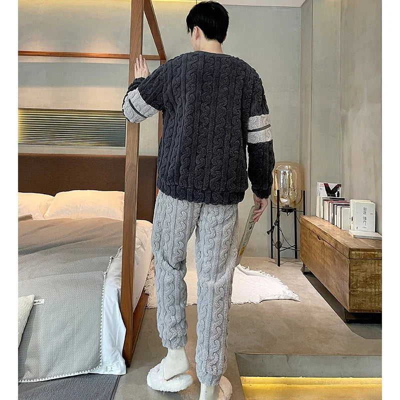Man in cozy cable knit sweater and pants with white stripes lounging in modern bedroom