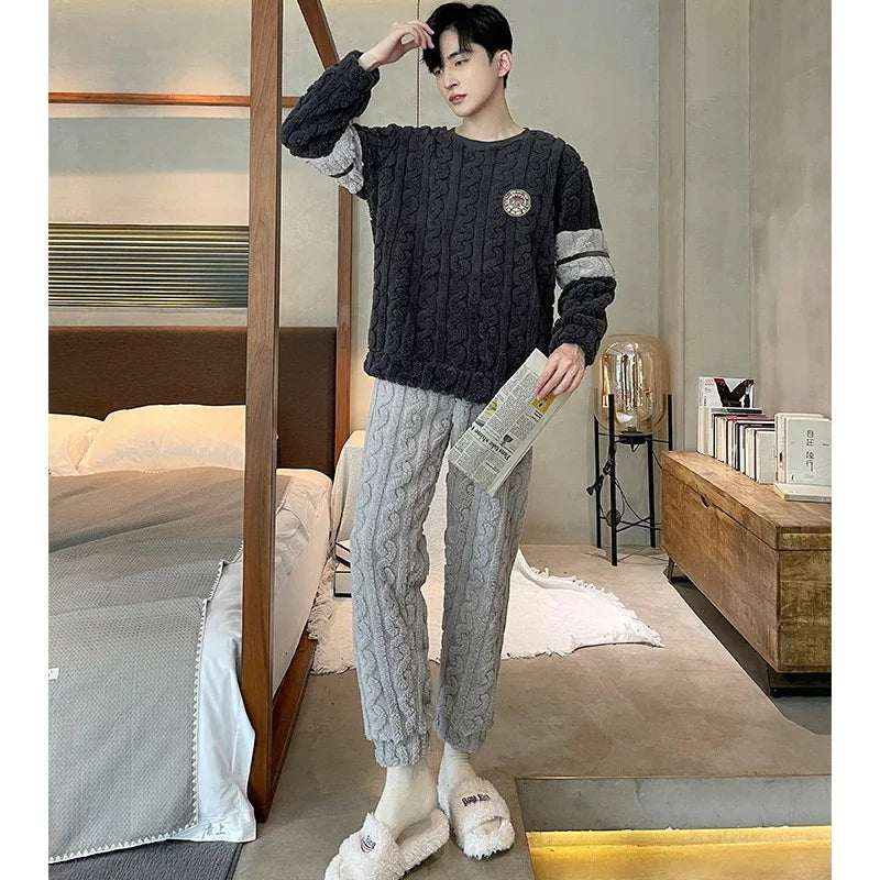 Young man in cozy cable-knit sweater and pants holding newspaper in modern bedroom