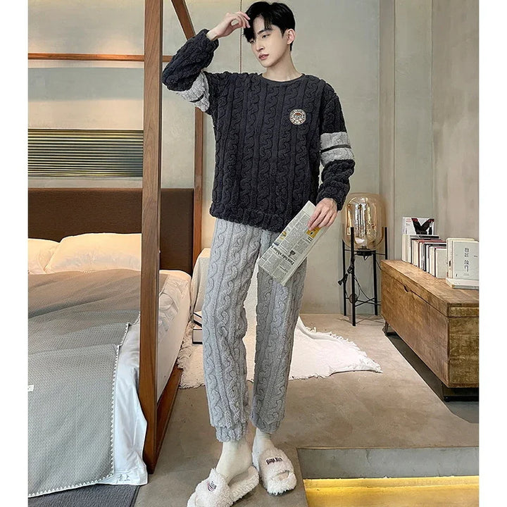 Young man in cozy cable-knit sweater and pants holding newspaper in modern bedroom