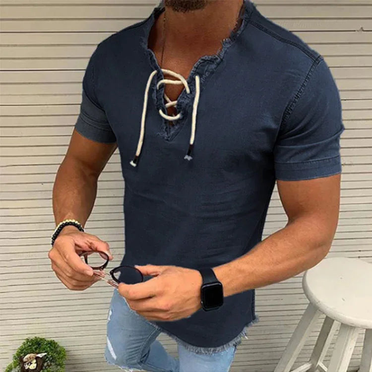 Man wearing fitted navy blue lace-up casual t-shirt with short sleeves and frayed hem, holding sunglasses
