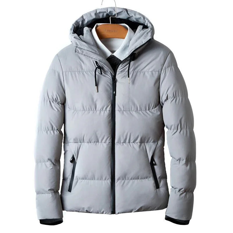 Light gray hooded puffer winter jacket with black zipper and drawstring on wooden hanger
