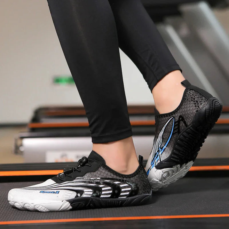 Person wearing black and white minimalist running shoes on treadmill, stylish fitness footwear